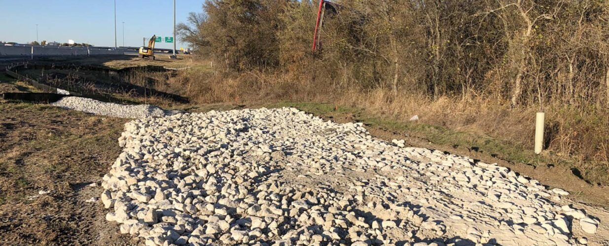 rocks on ground beside IH 35E widening project