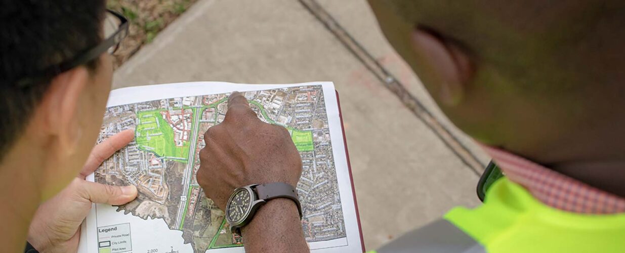 man pointing at GIS map