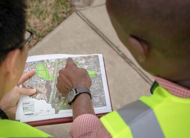 man pointing at GIS map