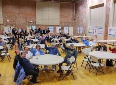 community people waving at meeting for Broken Arrow