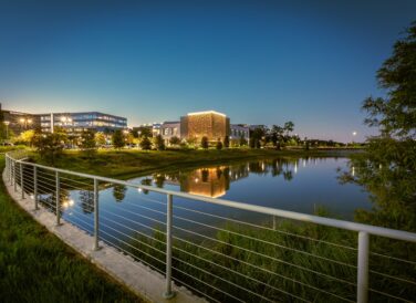 City Place buildings next to lake in the evening with lights