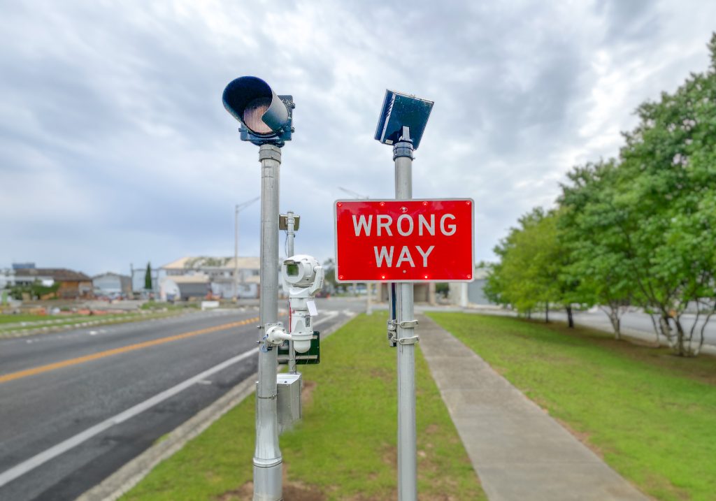 Wrong-way driver sign with flashing red lights ITS technology